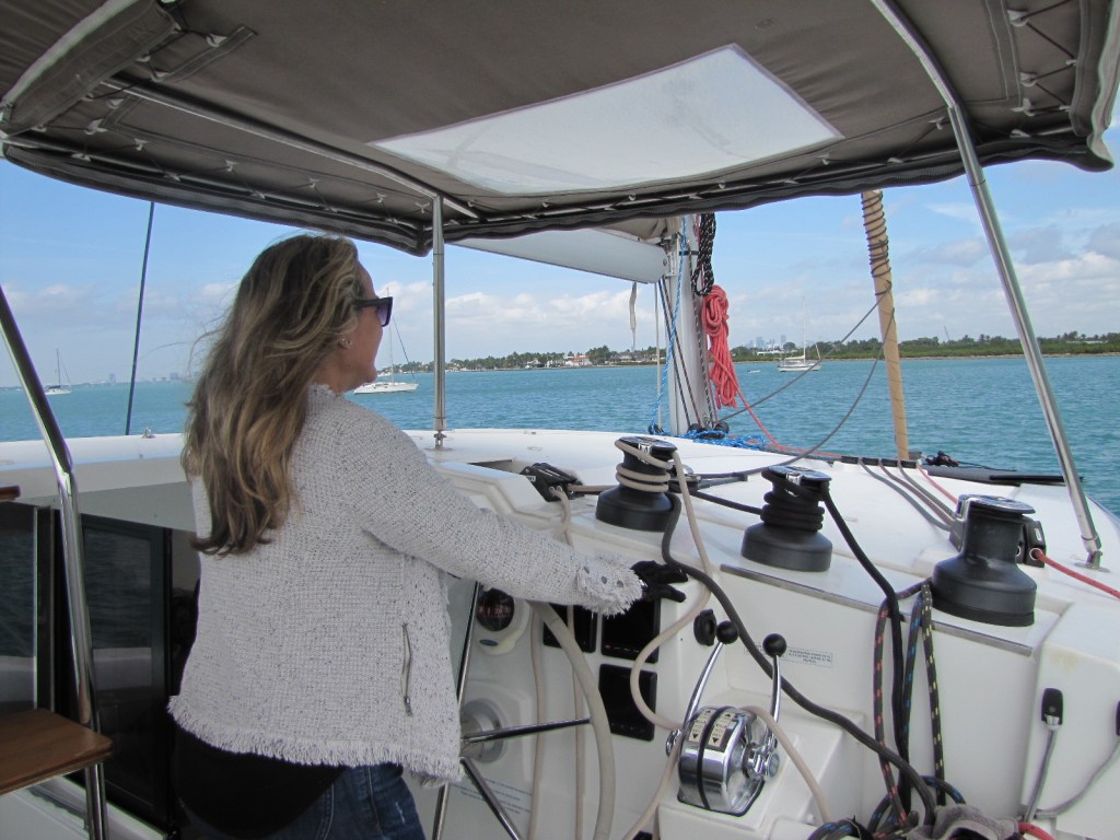 Gloria steering the ship from the helm